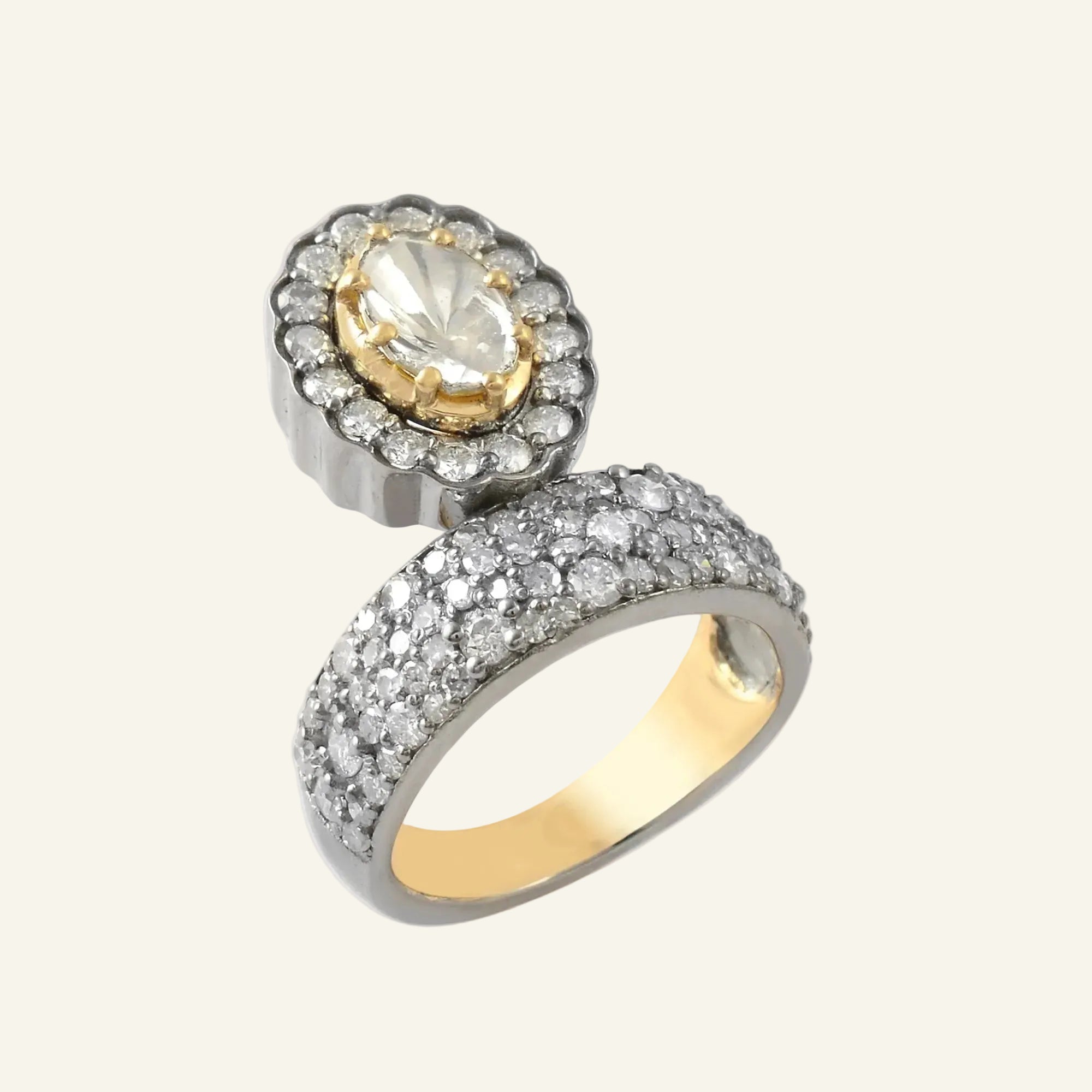 Gold and silver ring with a central gemstone on a white background